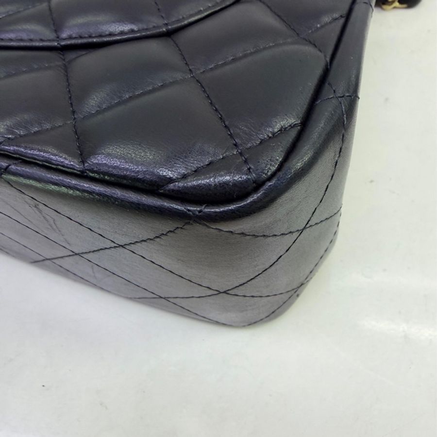 This is a Chanel Classic Double Flap bag in black leather with gold-tone hardware-12