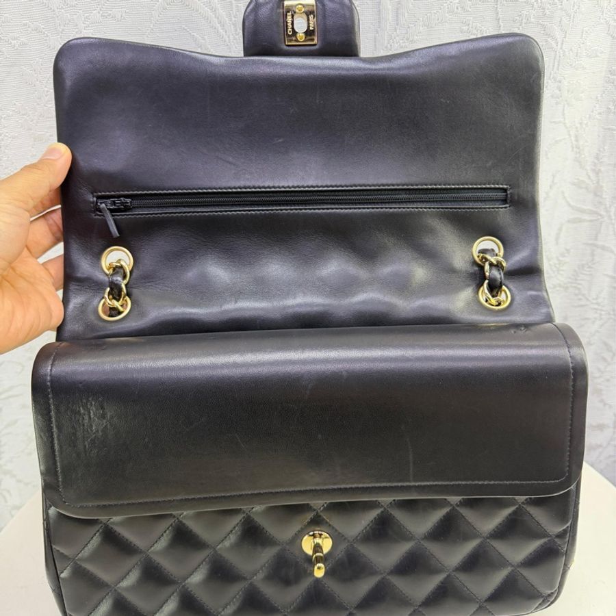 This is a Chanel Classic Double Flap bag in black leather with gold-tone hardware-14