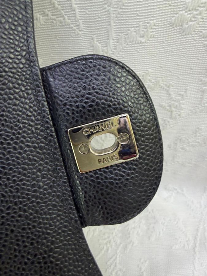 這是一只經典的黑色 CHANEL Classic Flap Jumbo 包款，採用耐用的魚子醬牛皮製成，並搭配銀色金屬鏈帶。-6